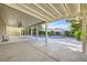 This home has a covered patio and backyard with a pool and lush landscaping at 386 Wiseton Ave, Las Vegas, NV 89183