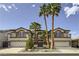 Stunning two-story home featuring a three-car garage, balconies, and meticulously manicured front yard with palm trees at 386 Wiseton Ave, Las Vegas, NV 89183