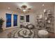 This staged living room features neutral tones, a modern ceiling fan, and stylish decor, creating a relaxing atmosphere at 386 Wiseton Ave, Las Vegas, NV 89183