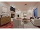 Inviting living room with a cozy fireplace, hardwood floors, neutral decor, and a sunlit window at 386 Wiseton Ave, Las Vegas, NV 89183