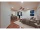 Staged bedroom featuring a ceiling fan, wood floors, and natural light at 386 Wiseton Ave, Las Vegas, NV 89183