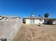 Backyard with block wall fence, a glimpse of neighboring houses, and minimal desert landscaping at 4321 El Conlon Ave, Las Vegas, NV 89102