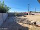 Large backyard enclosed by a block wall, featuring a small shed, a few plants, and a clear blue sky at 4321 El Conlon Ave, Las Vegas, NV 89102