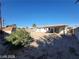 Expansive backyard with sparse desert landscaping, a storage shed, and a covered patio area at 4321 El Conlon Ave, Las Vegas, NV 89102