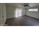 Bright bedroom with a ceiling fan, neutral paint, and sliding door leading to a private backyard at 4321 El Conlon Ave, Las Vegas, NV 89102