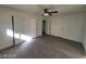 Spacious bedroom with new floors, ceiling fan, neutral paint and multiple closet doors at 4321 El Conlon Ave, Las Vegas, NV 89102