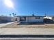 A quaint single-story home exhibiting desert landscaping with a driveway leading to a detached garage at 4321 El Conlon Ave, Las Vegas, NV 89102