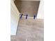 Modern gray vinyl flooring with molding being installed at a doorway, secured with blue painter's tape at 4321 El Conlon Ave, Las Vegas, NV 89102