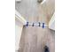 Modern gray vinyl flooring with molding being installed at a doorway, secured with blue painter's tape at 4321 El Conlon Ave, Las Vegas, NV 89102