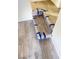 Recently installed vinyl flooring on the short steps of a staircase, secured with blue painter's tape at 4321 El Conlon Ave, Las Vegas, NV 89102