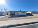 Single-story home featuring minimal landscaping and a concrete driveway under a bright blue sky at 4321 El Conlon Ave, Las Vegas, NV 89102