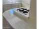 Kitchen featuring sleek countertops, a built-in stovetop, and white cabinets in a clean, modern design at 4321 El Conlon Ave, Las Vegas, NV 89102