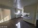 Spacious kitchen featuring a gas cooktop, white cabinets, and modern flooring at 4321 El Conlon Ave, Las Vegas, NV 89102