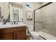 Modern bathroom with glass-enclosed shower, wooden vanity, and neutral tile, offering a spa-like feel at 436 Crown Mesa Ave, Las Vegas, NV 89138