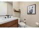 Contemporary half bath with dark wood vanity, bright countertops, and decorative shelving at 436 Crown Mesa Ave, Las Vegas, NV 89138