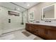 Modern bathroom showcases a frameless glass shower, dual vanities, and contemporary lighting at 436 Crown Mesa Ave, Las Vegas, NV 89138