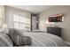 Well-lit bedroom featuring a stylish bed, dark dresser, and modern decor for added comfort at 436 Crown Mesa Ave, Las Vegas, NV 89138