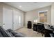 Versatile bedroom space with a gray futon, closet, and desk perfect for a guest room or home office at 436 Crown Mesa Ave, Las Vegas, NV 89138