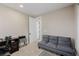 Bedroom space featuring a comfy gray futon, desk, and closet perfect for guests or a home office at 436 Crown Mesa Ave, Las Vegas, NV 89138
