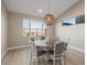 Dining room with a round wood table, seating for six, and large windows with a view at 436 Crown Mesa Ave, Las Vegas, NV 89138