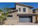 Modern two-story home with a gray roof, a two-car garage with a sleek gray door and drought-tolerant landscaping at 436 Crown Mesa Ave, Las Vegas, NV 89138