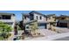 Stylish two-story home featuring a modern garage door and landscaped front yard at 436 Crown Mesa Ave, Las Vegas, NV 89138