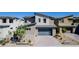 Stylish two-story home featuring a modern garage door and landscaped front yard at 436 Crown Mesa Ave, Las Vegas, NV 89138
