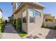 Modern home exterior featuring a landscaped walkway with manicured bushes and a concrete driveway at 436 Crown Mesa Ave, Las Vegas, NV 89138