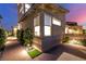 Well-lit walkway leading to a modern home, surrounded by manicured landscaping and decorative stones at 436 Crown Mesa Ave, Las Vegas, NV 89138