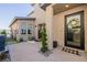 Home's welcoming entrance features a modern black front door and a well-kept porch with decorative plants at 436 Crown Mesa Ave, Las Vegas, NV 89138