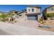 Stylish modern home with a gray roof, a gray two-car garage, and manicured drought-tolerant landscaping at 436 Crown Mesa Ave, Las Vegas, NV 89138