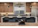 Stylish kitchen island with modern pendant lights, counter seating and stainless steel appliances at 436 Crown Mesa Ave, Las Vegas, NV 89138