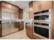 Modern kitchen featuring stainless steel appliances, wood cabinets, and light wood flooring at 436 Crown Mesa Ave, Las Vegas, NV 89138