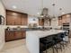 Bright kitchen with a large island, bar seating, stainless steel appliances, and pendant lighting at 436 Crown Mesa Ave, Las Vegas, NV 89138