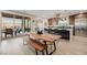 Open floor plan featuring kitchen with island seating opening to an outdoor patio with views at 436 Crown Mesa Ave, Las Vegas, NV 89138