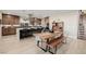 Open-concept kitchen featuring a large island with seating, stainless appliances and wood cabinets at 436 Crown Mesa Ave, Las Vegas, NV 89138