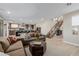 Open concept living area with modern staircase, living room, and kitchen at 436 Crown Mesa Ave, Las Vegas, NV 89138