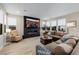 Cozy living room features a fireplace with stone accent wall, large sectional sofa, and bright natural light at 436 Crown Mesa Ave, Las Vegas, NV 89138
