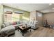 Bright living room features contemporary sectional and wood flooring at 436 Crown Mesa Ave, Las Vegas, NV 89138