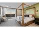 Bright main bedroom boasts a four poster bed, a private balcony, and stylish decor at 436 Crown Mesa Ave, Las Vegas, NV 89138