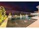 Backyard pool with water features and manicured garden at dusk at 436 Crown Mesa Ave, Las Vegas, NV 89138