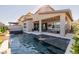 Gorgeous backyard with a luxurious pool and comfortable patio seating, ideal for entertaining at 436 Crown Mesa Ave, Las Vegas, NV 89138