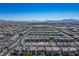 High angle view of a suburban community with similar style houses and mountain backdrop at 4634 Observed St, North Las Vegas, NV 89031