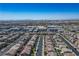 Elevated view of a residential area showing homes and community buildings, city visible afar at 4634 Observed St, North Las Vegas, NV 89031