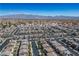Aerial shot showcases a neighborhood with rows of houses set against a mountainous skyline at 4634 Observed St, North Las Vegas, NV 89031