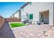 Spacious backyard features brick pavers, a small patch of artificial grass, and stylish patio furniture at 4634 Observed St, North Las Vegas, NV 89031
