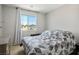 Bedroom with gray walls, carpeted floor, a small bed and plenty of natural light at 4634 Observed St, North Las Vegas, NV 89031