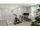 Bonus room with gray walls, carpeted floor, stationary bike, desk, chair, and natural light at 4634 Observed St, North Las Vegas, NV 89031