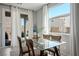 Cozy dining space with glass table, neutral chairs, and natural light, providing a comfortable atmosphere at 4634 Observed St, North Las Vegas, NV 89031