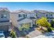 Inviting two-story home with a well-manicured front yard and a charming, neutral-toned exterior at 4634 Observed St, North Las Vegas, NV 89031